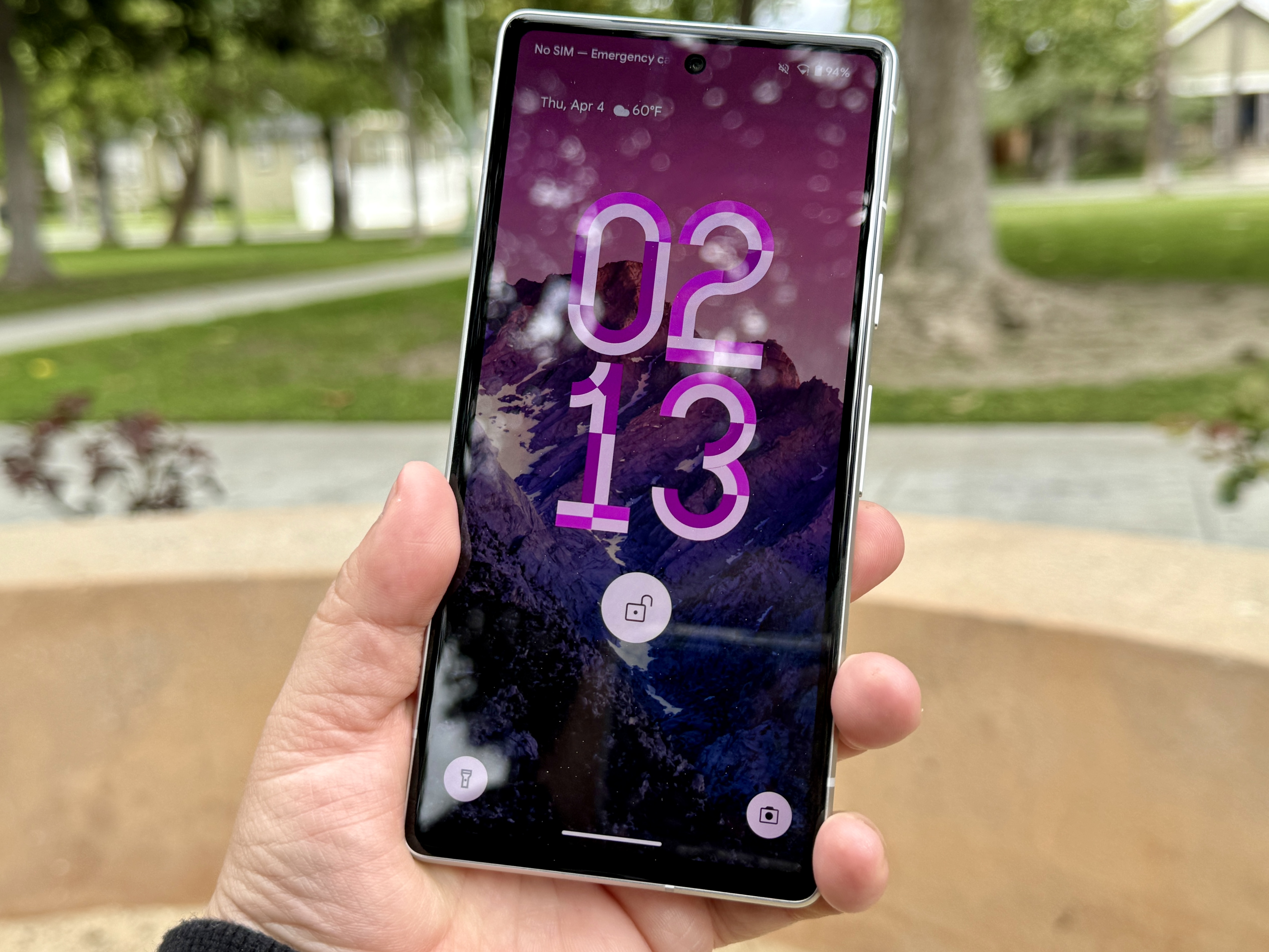 Google Pixel 7a in Snow showing new lock screen clock designs.