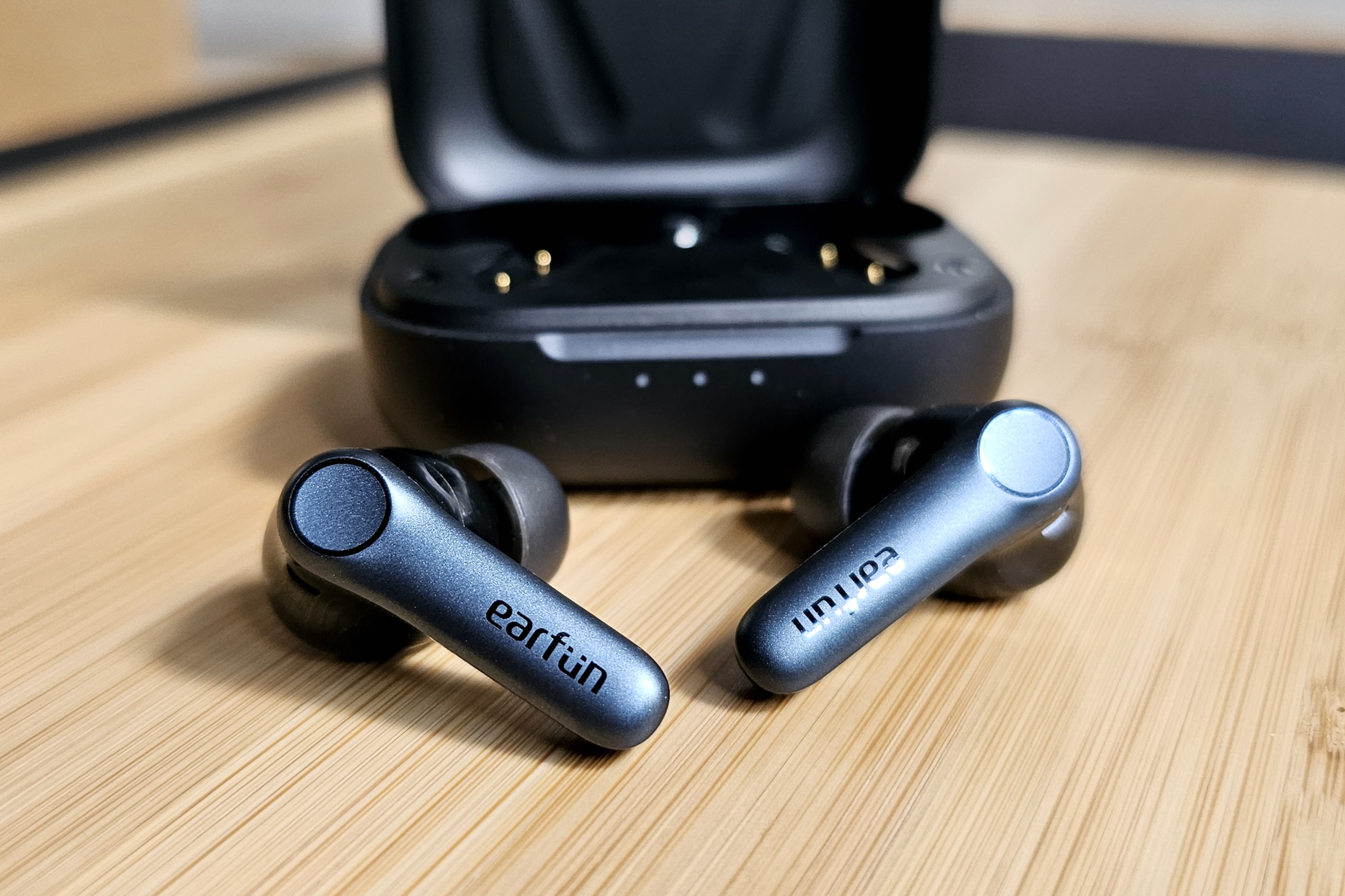 Earfun Air Pro 4 in front of case.