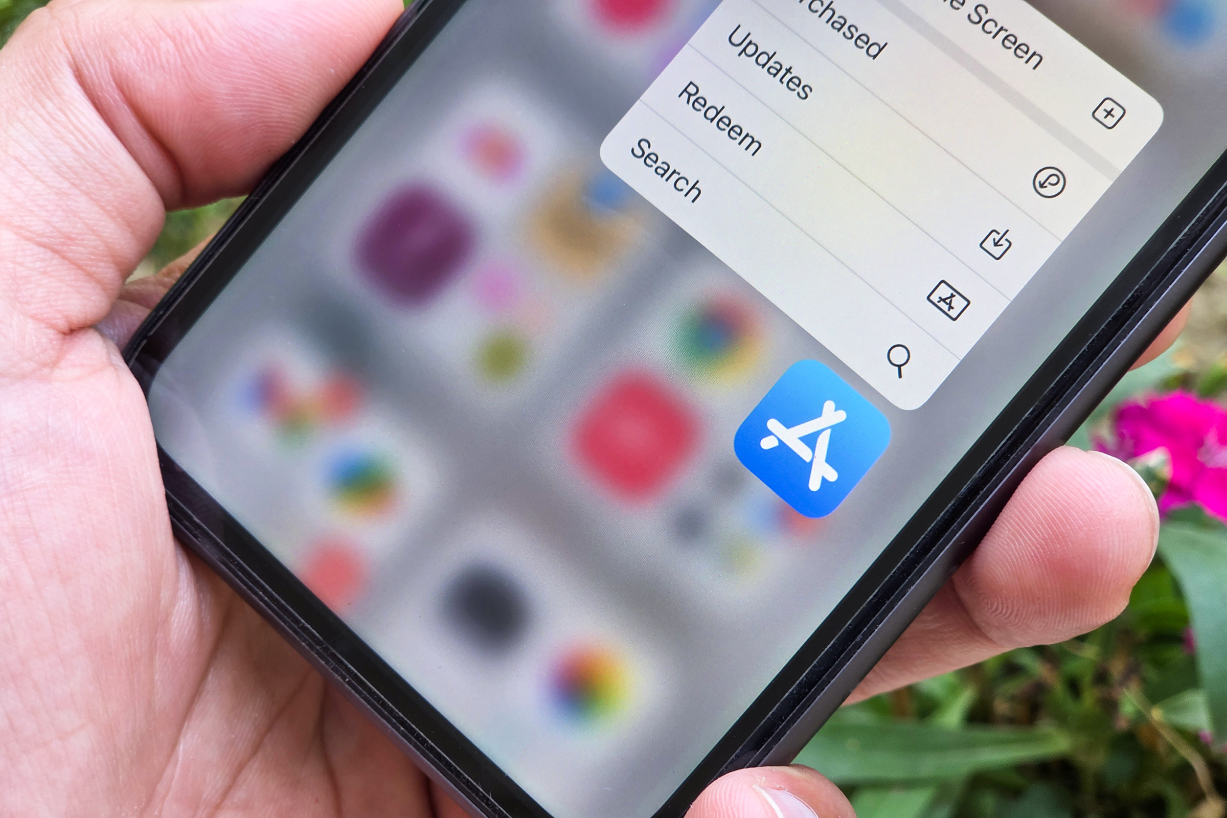 Apple iOS App Store logo on iPhone.